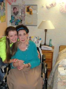The author and Frances together. Behind them is a weathered photograph of Frances's late son, Raymond Scott. The blue butterfly is a drawing made by the author for Frances who has always seen butterflies as a sign of hope and a sign of love from her son. Also, Frances's outfit theme was blue that day.