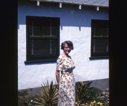 "Mary, outside the first little home we bought."