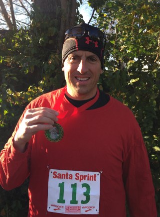 The author at the finish line with his Santa Sprint medal